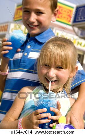 Kids eating carnival food View Large Photo Image Picture - Kids eating carnival food. Fotosearch