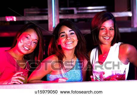 Young adults at a nightclub View Large Photo Image Stock Image - Young adults at a nightclub. Fotosearch