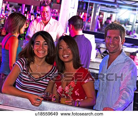 Young adults at a nightclub View Large Photo Image Stock Photo - Young adults at a nightclub. Fotosearch