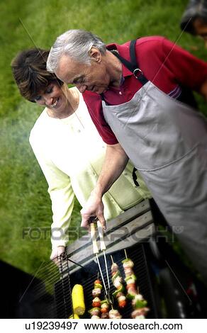 Couple grilling View Large Photo Image Stock Photo - Couple grilling. Fotosearch