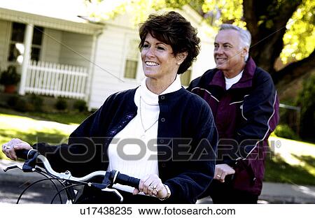 Couple riding bicycles View Large Photo Image Stock Photography - Couple riding bicycles. Fotosearch