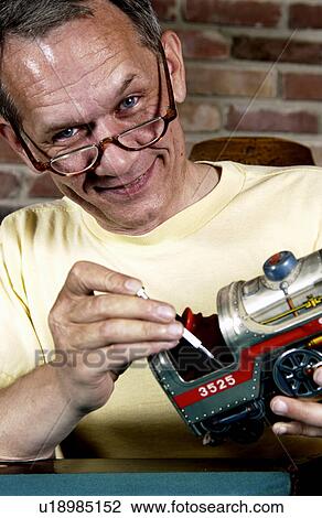 Man repairing a model train View Large Photo Image Stock Image - Man repairing a model train. Fotosearch