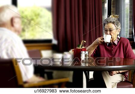Stock Image - Senior couple eating a meal. Fotosearch