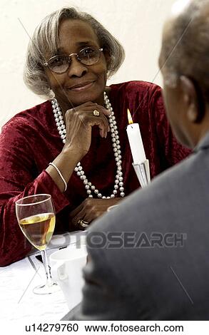 Stock Image - Senior couple having a romantic meal. Fotosearch