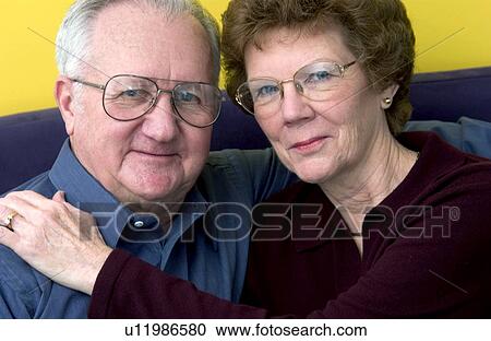 Stock Image - Senior couple on couch. Fotosearch