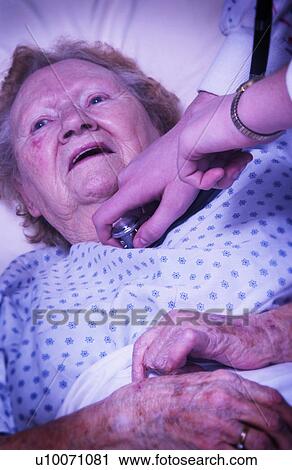 Stock Image - Senior woman sick in bed. Fotosearch