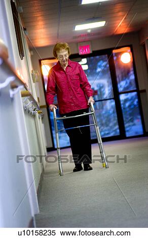 Stock Photography - Senior woman walking with walker. Fotosearch