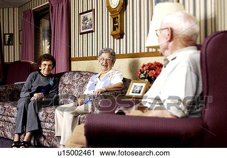 Stock Image - Seniors in nursing home visiting. Fotosearch