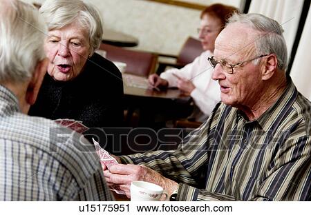 Stock Image - Seniors playing cards. Fotosearch