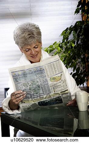 Stock Image - Woman reading newspaper. Fotosearch