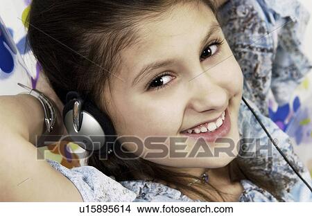 Picture - Girl listening to headphones. Fotosearch