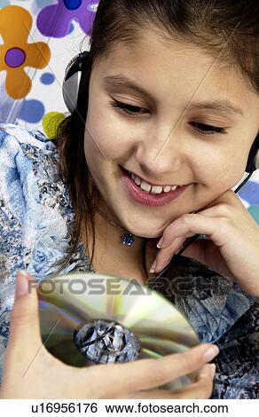 Stock Photograph - Girl listening to headphones. Fotosearch