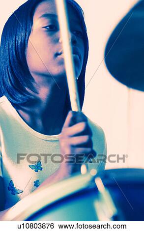 Stock Photograph - Girl playing drums. Fotosearch