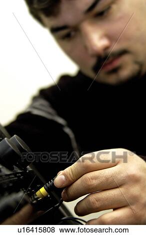 Stock Photo - Man fixing stereo. Fotosearch