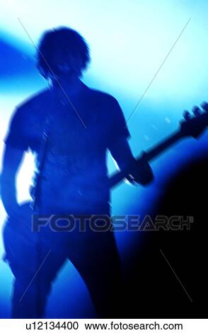 Stock Image - Man playing bass guitar. Fotosearch