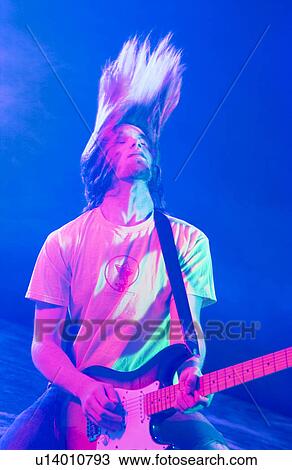 Stock Image - Man playing guitar. Fotosearch