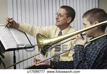 Stock Photo - Music teacher with student. Fotosearch