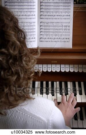 Stock Photography - Woman playing organ. Fotosearch