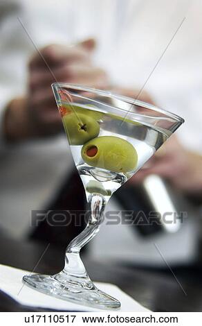 Martini with bartender in background View Large Photo Image Stock Photo - Martini with bartender in background. Fotosearch