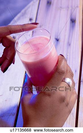 Person holding alcoholic drink View Large Photo Image Stock Photo - Person holding alcoholic drink. Fotosearch