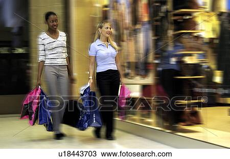 Two girls shopping at a mall View Large Photo Image Stock Image - Two girls shopping at a mall. Fotosearch