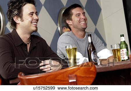 Stock Photo - Two men drinking at a bar. Fotosearch