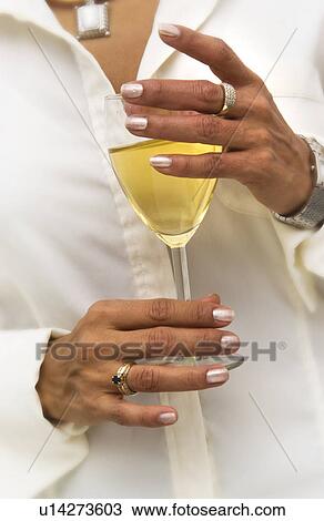 Stock Image - Woman holding drink. Fotosearch