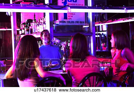 Young adults at a nightclub View Large Photo Image Stock Photo - Young adults at a nightclub. Fotosearch