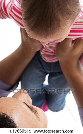 Stock Photography - African American father holding daughter. Fotosearch