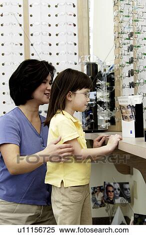 Asian mom and daughter choosing eyeglasses View Large Photo Image Stock Photography - Asian mom and daughter choosing eyeglasses. Fotosearch