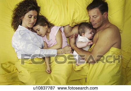 Stock Photo - Family lying in bed. Fotosearch