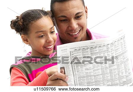 Stock Photograph - Father and daughter reading newspaper. Fotosearch