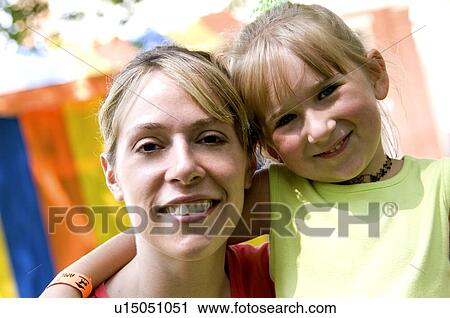Stock Image - Mother and daughter at carnival. Fotosearch