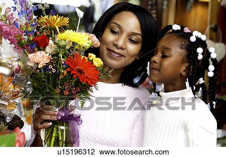 Stock Image - Mother and daughter at florist. Fotosearch