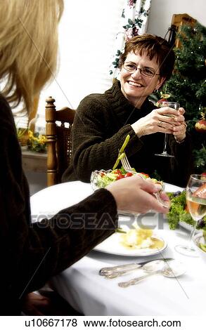 Stock Photo - Mother and daughter at holiday dinner. Fotosearch