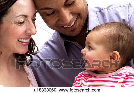 Mother and Father holding daughter View Large Photo Image Stock Image - Mother and Father holding daughter. Fotosearch