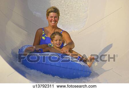 Mother and son going down water slide View Large Photo Image Stock Image - Mother and son going down water slide. Fotosearch