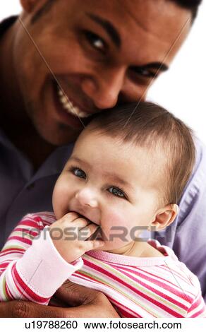 Stock Image - African American father holding daughter. Fotosearch