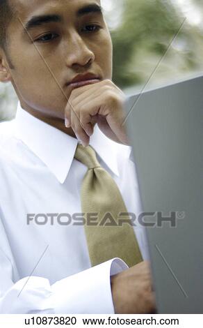 Businessman working on laptop View Large Photo Image Stock Image - Businessman working on laptop. Fotosearch