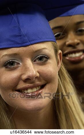Picture - Girls in cap and gown for graduation. Fotosearch