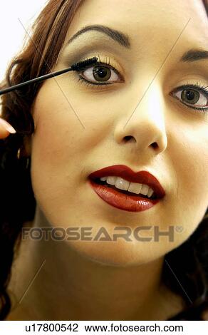 Woman applying makeup View Large Photo Image Stock Image - Woman applying makeup. Fotosearch