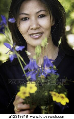 Woman with flowers View Large Photo Image Stock Photo - Woman with flowers. Fotosearch