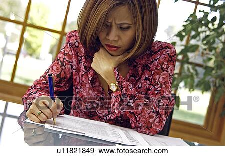 Stock Photo - Woman working at table. Fotosearch