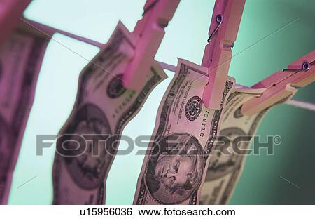 Bills hanging from clothesline View Large Photo Image Stock Photograph - Bills hanging from clothesline. Fotosearch