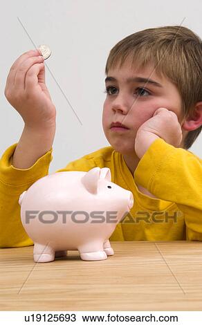 Stock Image - Boy with piggy bank. Fotosearch