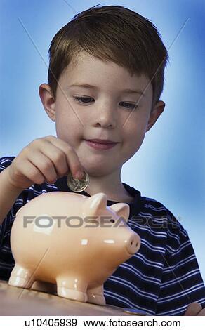 Stock Photo - Boy with piggy bank. Fotosearch