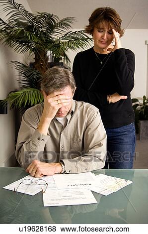 Stock Photo - Couple debating bankruptcy. Fotosearch
