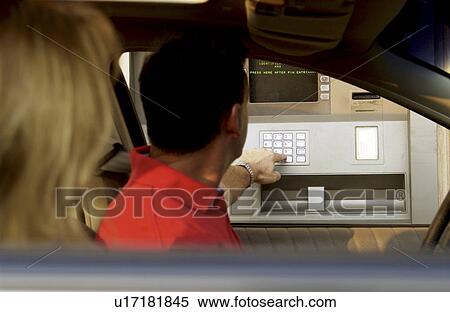 Stock Photography - Couple in car at ATM. Fotosearch
