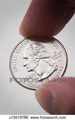 Stock Photograph - Hand holding quarter. Fotosearch