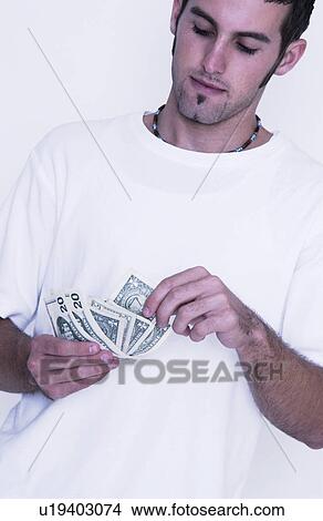 Man counting his money View Large Photo Image Picture - Man counting his money. Fotosearch